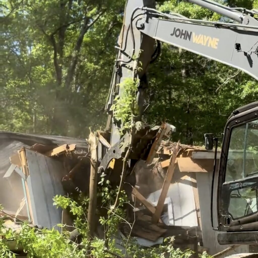 Kobelco SK210 Excavator demolishing a residential house during a professional demolition project in Metro Atlanta, Georgia.